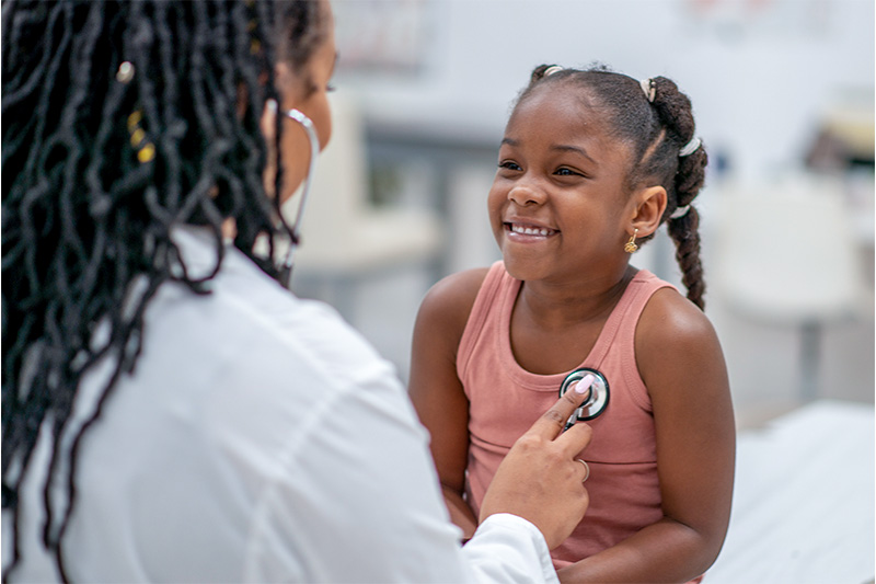 How to Prevent Strep Throat in Children | Picture of a pediatrician checking a young girl's heart